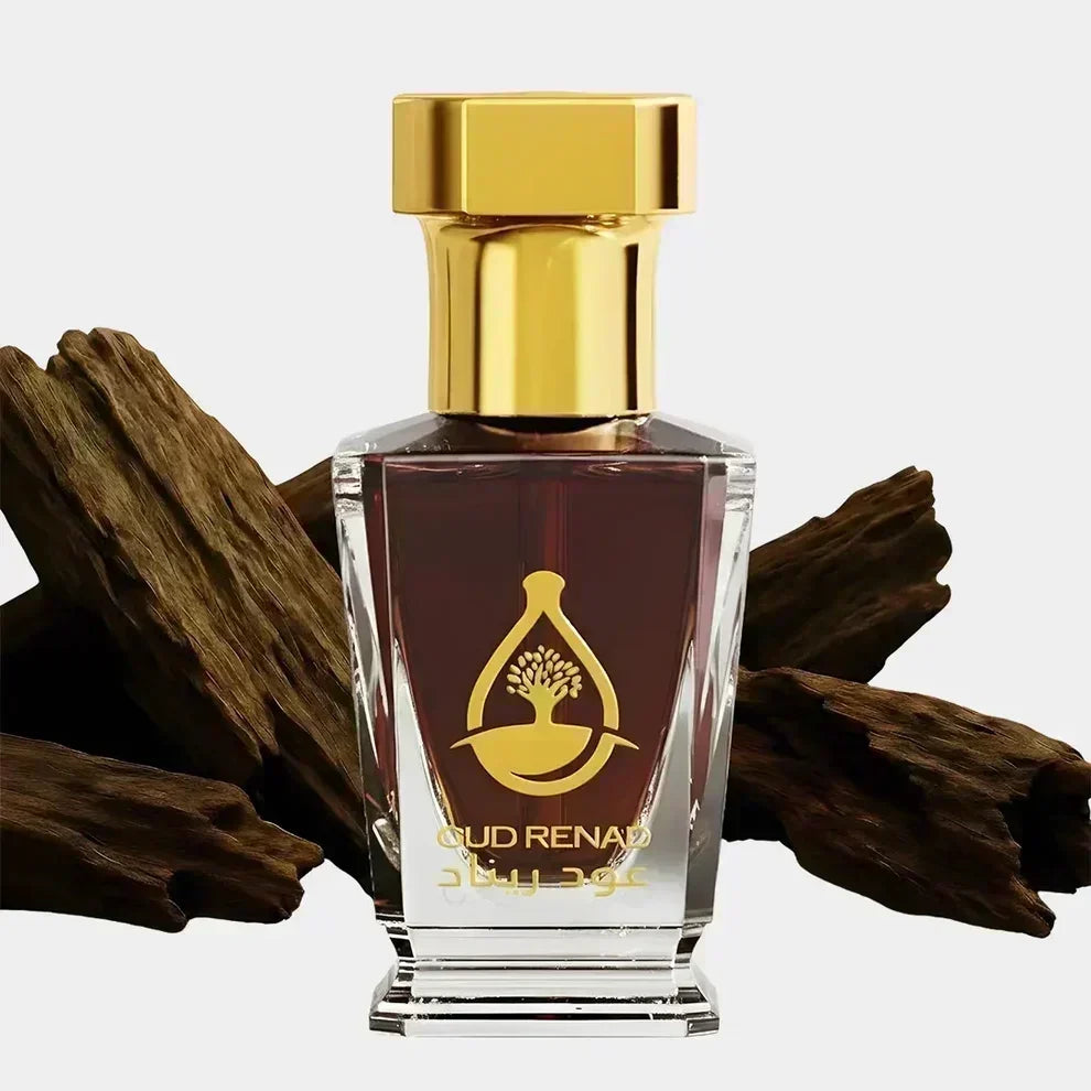 Oud Perfume Oil in the UK bottle with rich amber oud oil, gold cap and natural agarwood pieces.